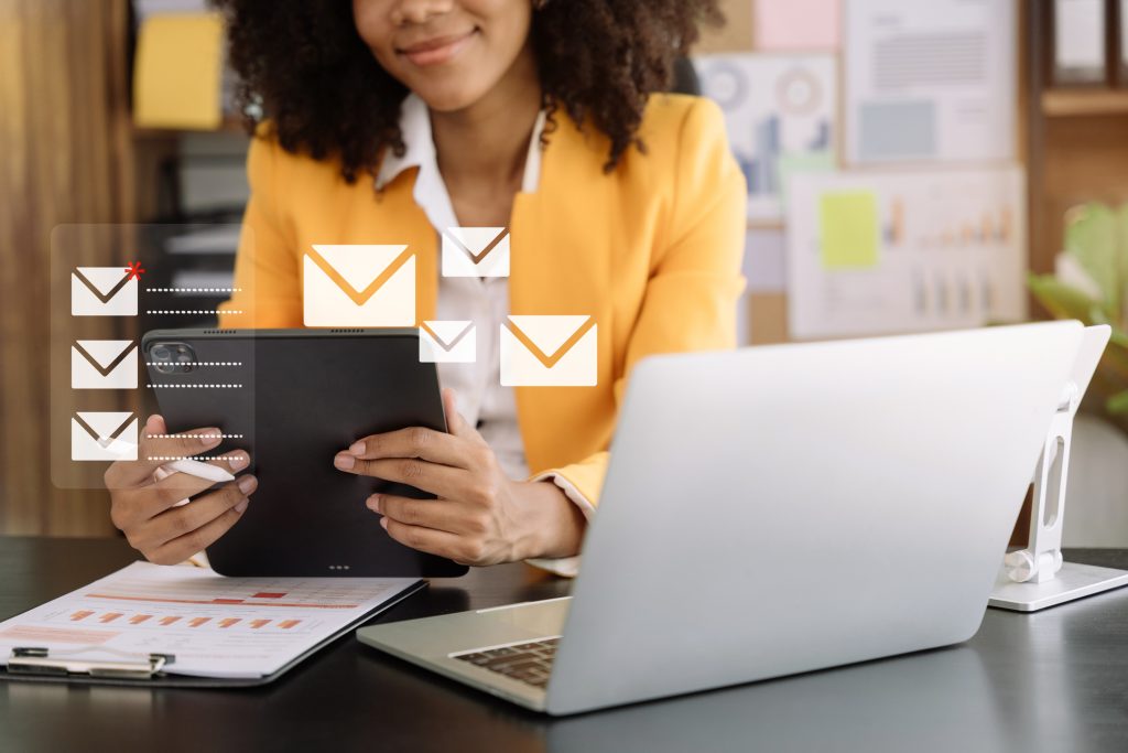 Conceito de notificação de e-mail marketing empresarial, empresária usar tablet e laptop receber alerta de mensagem na caixa de correio e transferir dados no escritório.